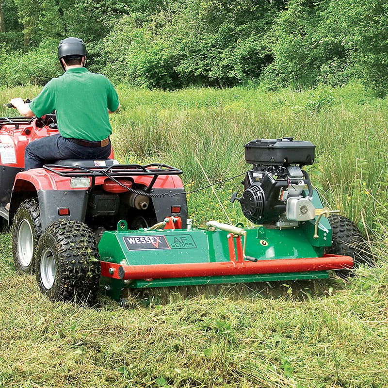 Flail mower attached to atv mowing grass