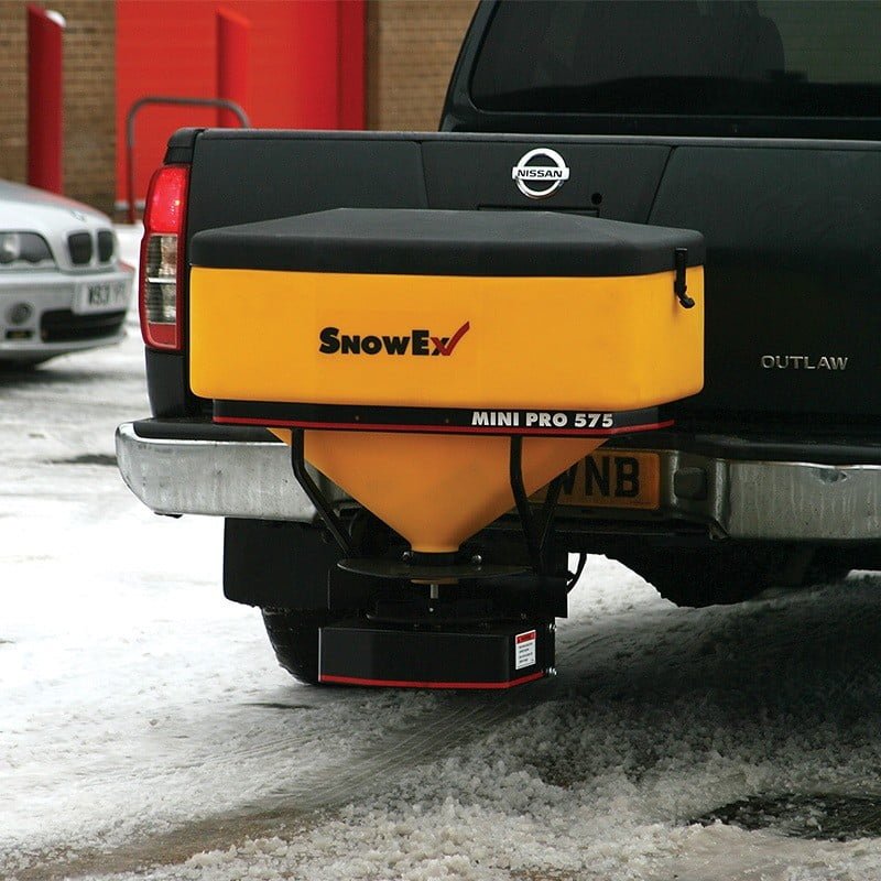 SnowEx salt spreader mounted to truck on icy road